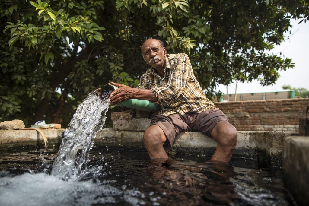 Farmer Raman Parmar on his farm with the IWMIs solar pump pilot in Thamna village near Anand